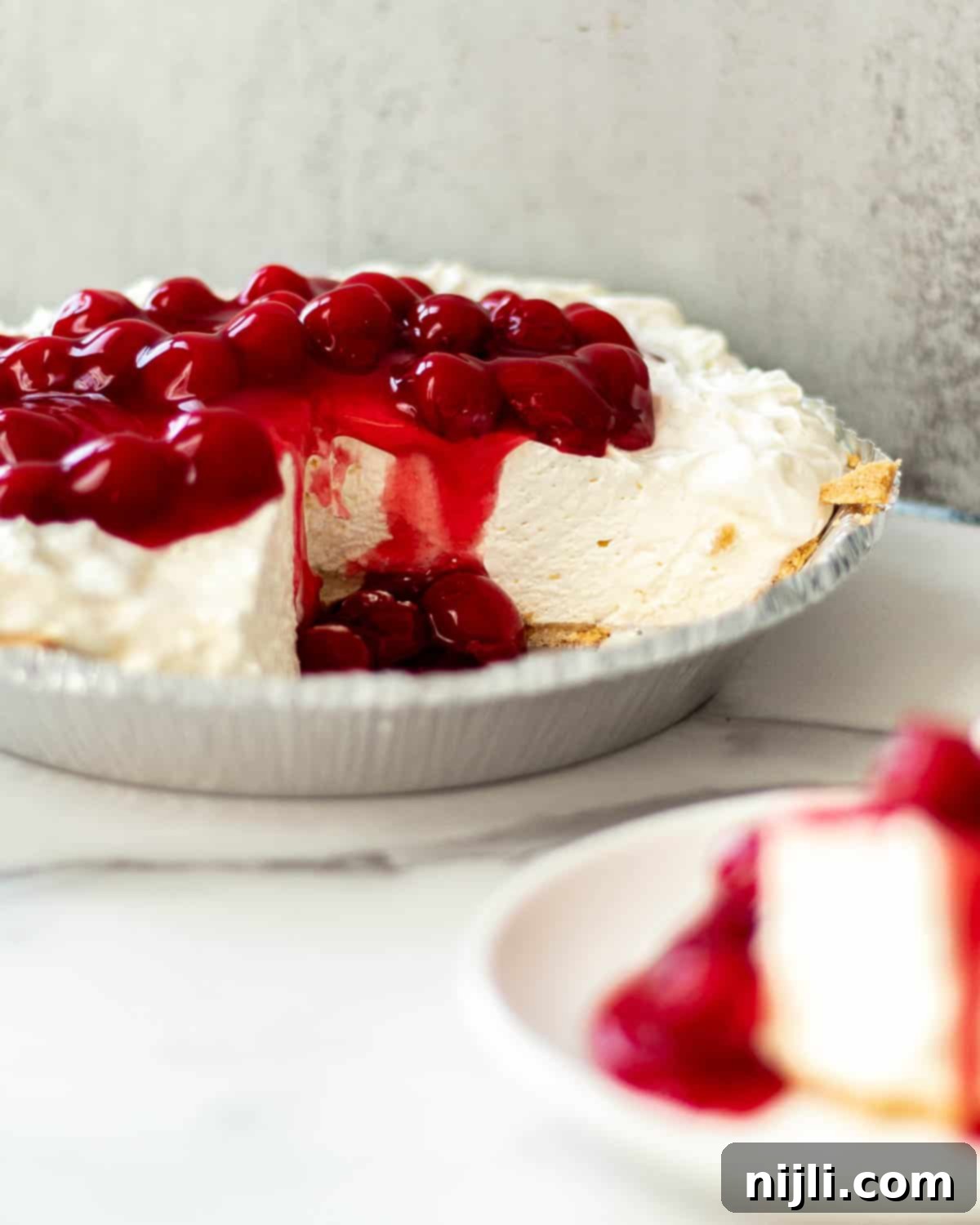 No-Bake Philadelphia Cool Whip Cheesecake 3 A slice of pie featuring a five-ingredient no-bake cheesecake filling, topped with fresh berries.