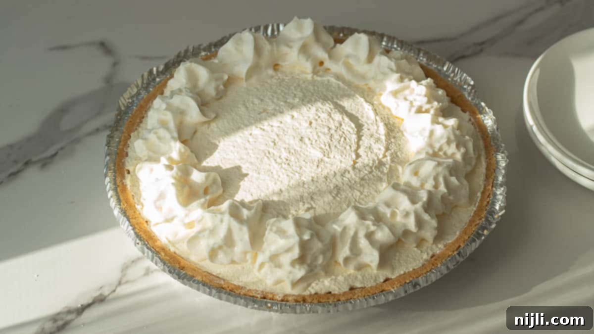No-Bake Philadelphia Cool Whip Cheesecake 4 An overhead shot showcasing the ingredients for the no-bake cheesecake recipe, including 8 oz cream cheese and Cool Whip.