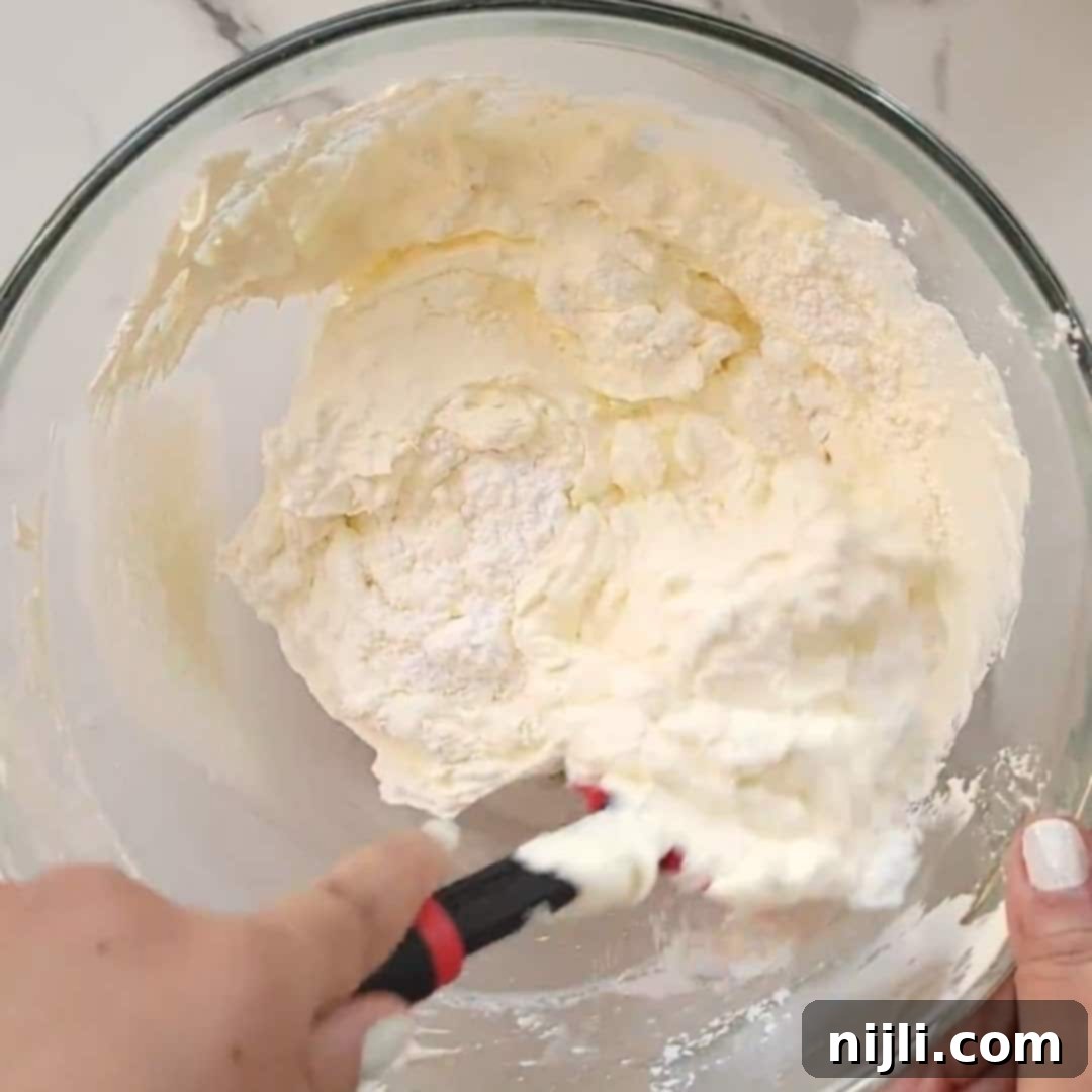 No-Bake Philadelphia Cool Whip Cheesecake 5 Step 1: Combine cream cheese, powdered sugar, whipped topping, and vanilla in a large bowl for the no-bake cheesecake.