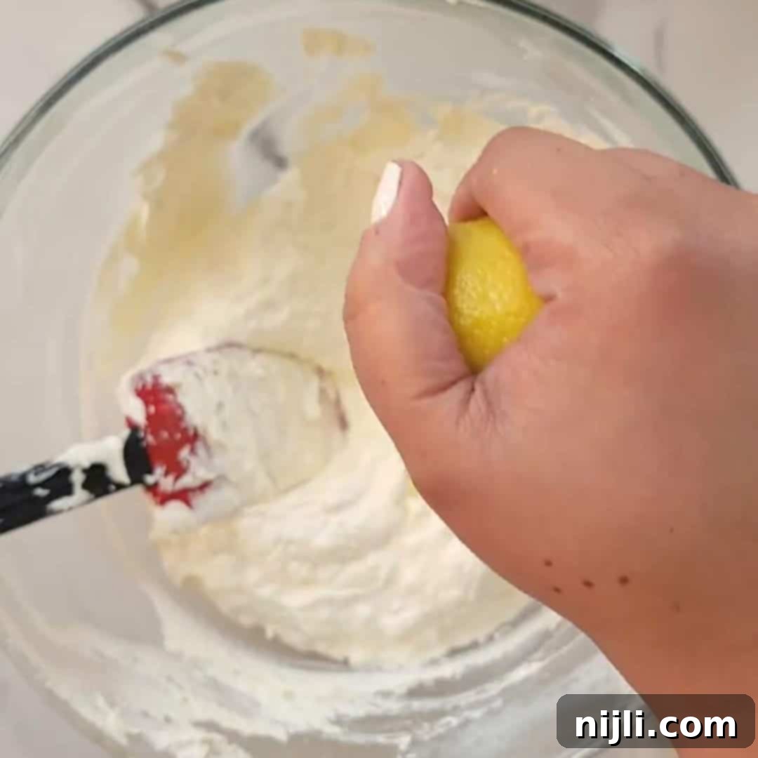 No-Bake Philadelphia Cool Whip Cheesecake 6 Step 2: Add lemon juice and stir until the no-bake cheesecake filling is smooth, ensuring to scrape the sides of the bowl.