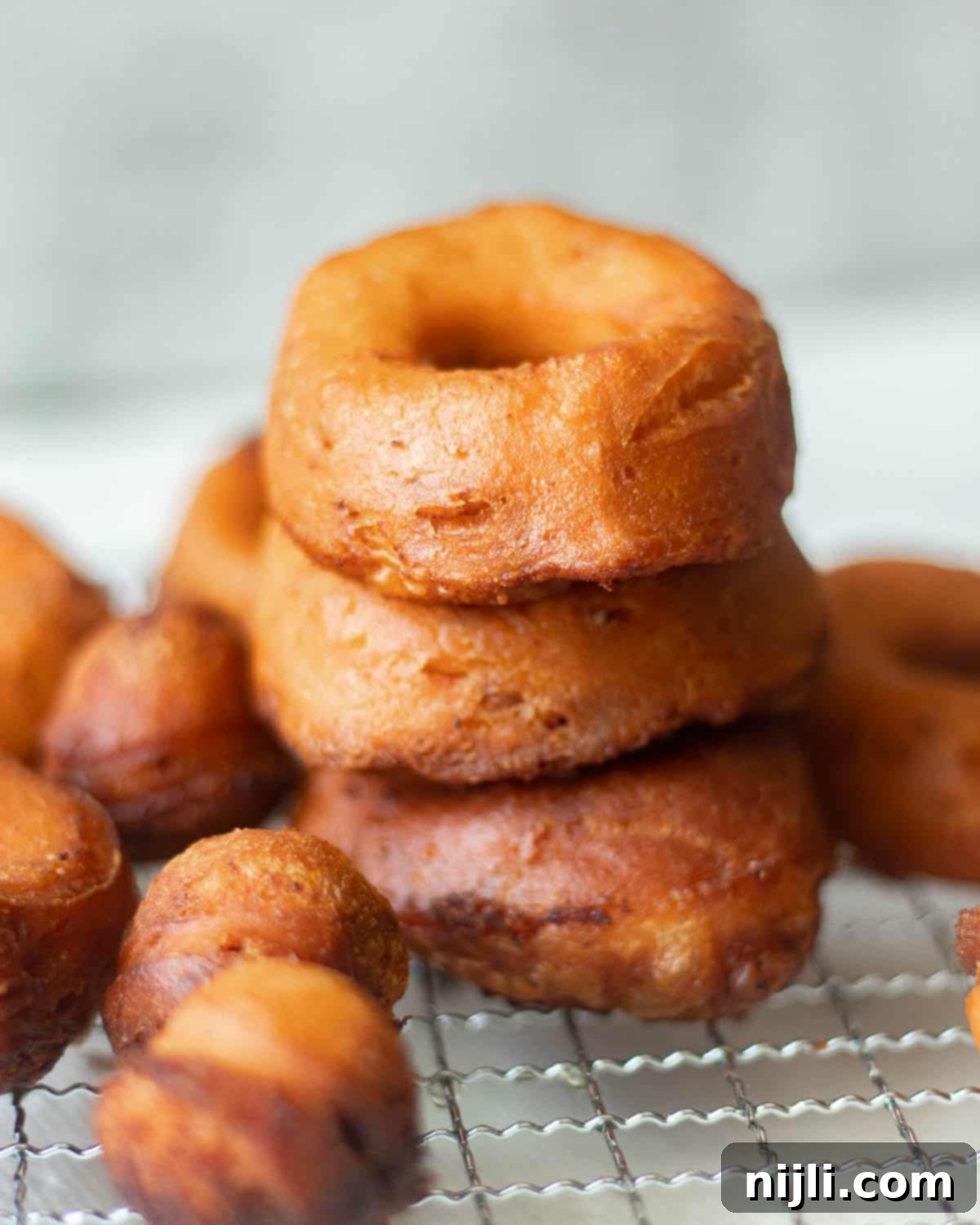 Pillsbury's Signature Cinnamon Swirl Donuts 3 cinnamon roll donuts stacked on a tray