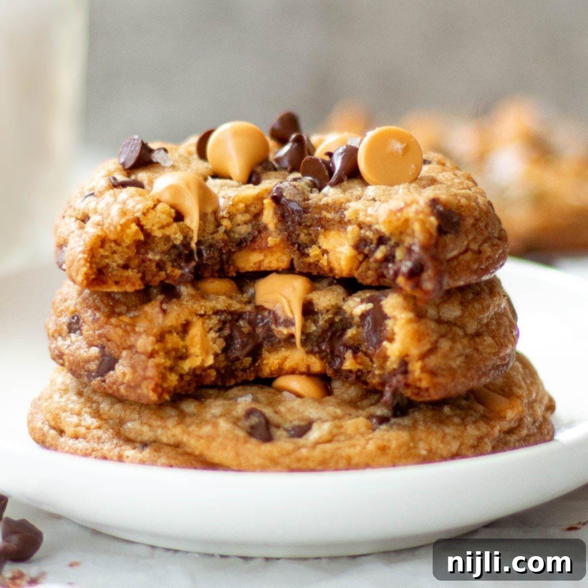 Butterscotch Chocolate Chip Cookies 2 Butterscotch chocolate chip cookies stacked on a white plate.