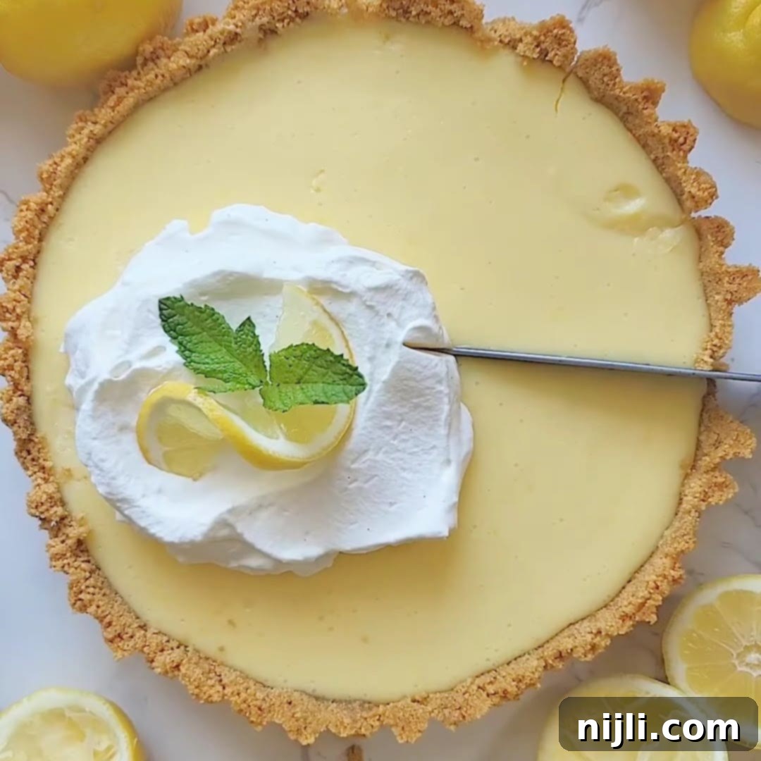 Zesty Lemon Icebox Pie 12 Cutting into a finished lemon icebox pie.