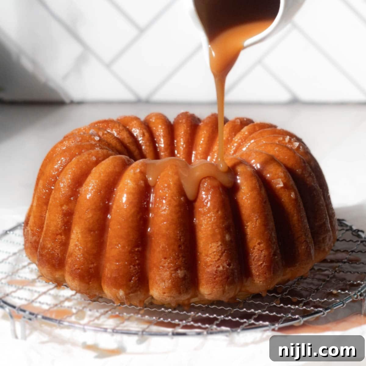 Golden Kentucky Butter Cake with Salted Caramel Glaze 2 salted caramel kentucky butter cake with caramel pouring on top