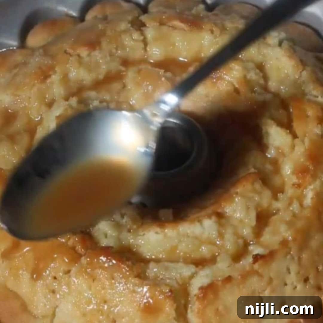 Golden Kentucky Butter Cake with Salted Caramel Glaze 13 baked salted caramel kentucky butter cake in Bundt pan, with spoon drizzling caramel sauce