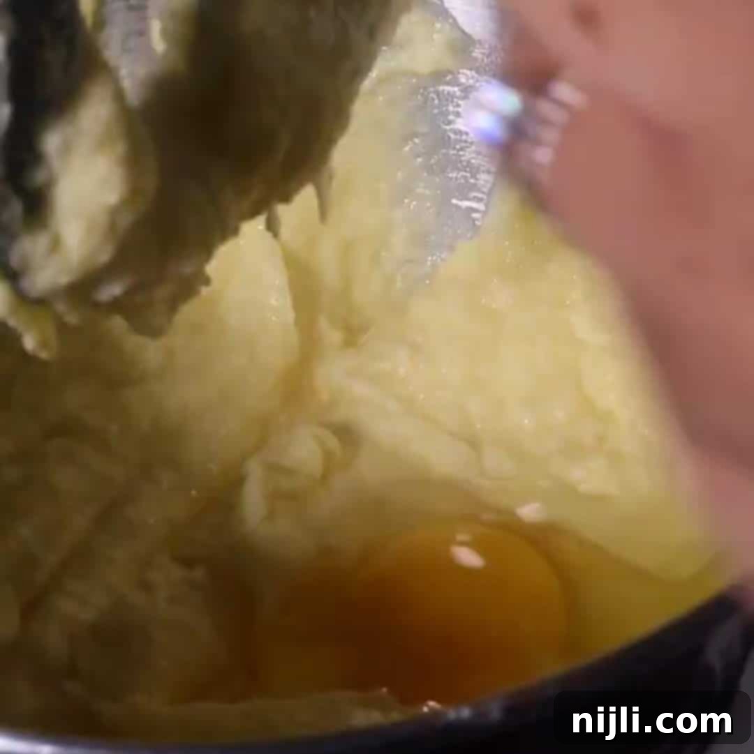 Golden Kentucky Butter Cake with Salted Caramel Glaze 8 adding eggs to salted caramel kentucky butter cake batter