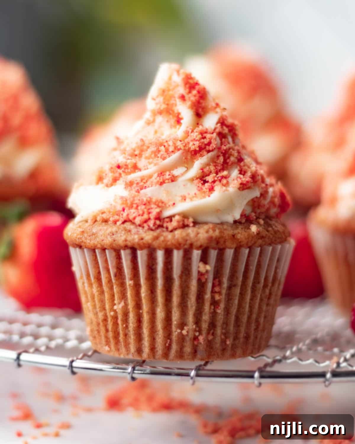 Strawberry Crunch Cupcakes 13 Strawberry crunch cupcakes with golden cake bases, rich frosting, and a vibrant red strawberry crumb topping.