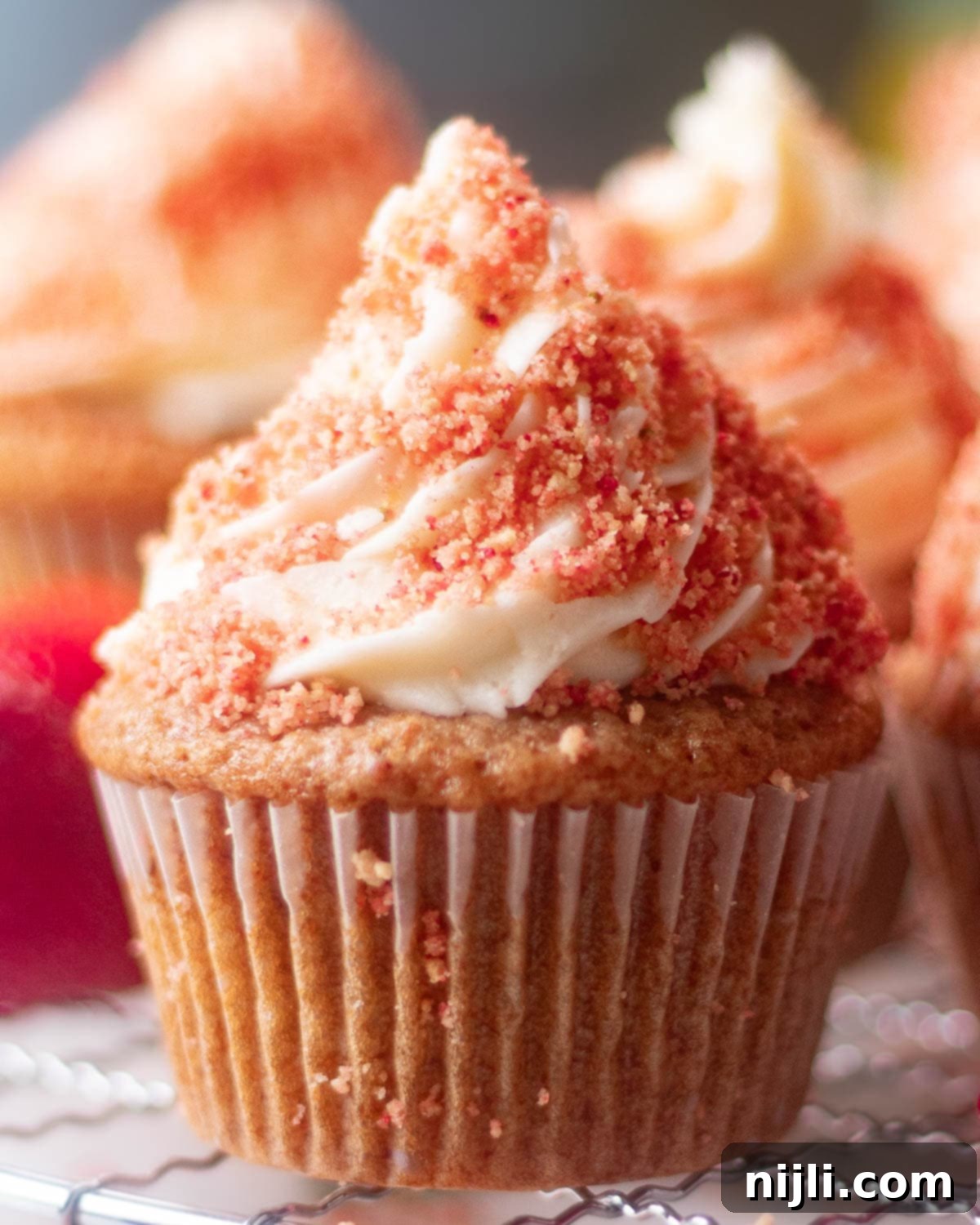 Strawberry Crunch Cupcakes 6 A vibrant array of strawberry crunch cupcakes, each with a creamy top and strawberry crumble, promising a burst of flavor.