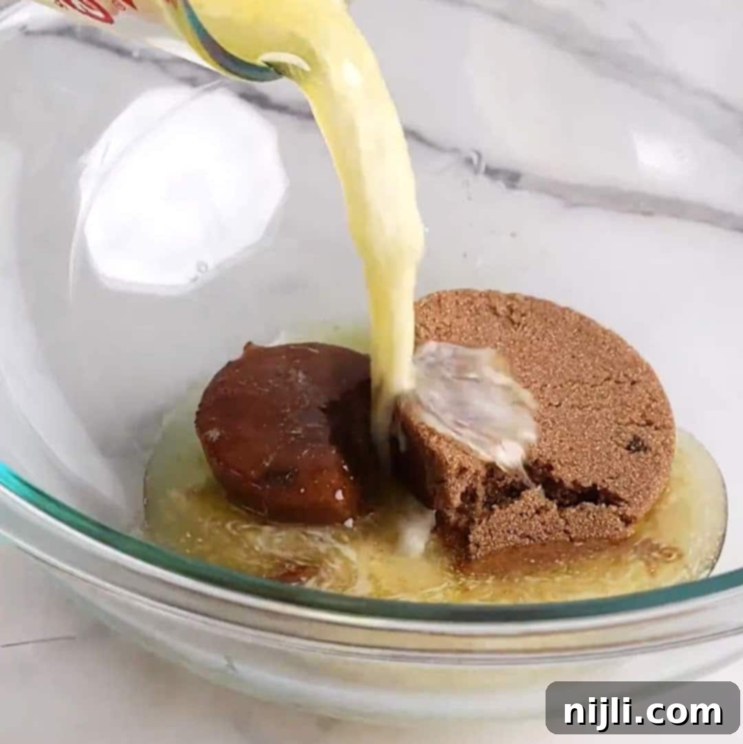 Bite-Sized Brownies 8 Pouring melted butter into a glass bowl containing brown sugar and molasses.