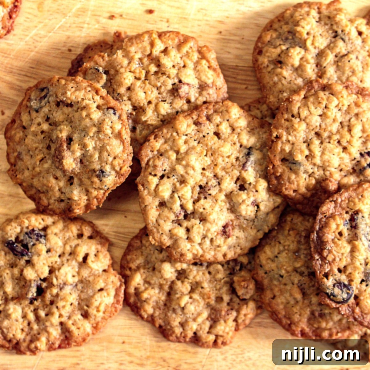 Chewy Oatmeal Cranberry Pecan Cookies 6 Overhead view of oatmeal cranberry pecan cookies, golden brown with visible oats, cranberries, and pecans