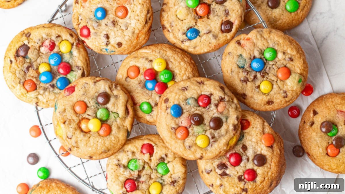 Festive Christmas M&M chocolate chip cookies, featuring red and green M&M candies paired with rich chocolate chips, perfect for holiday baking. These cookies are soft, thick, and bursting with seasonal colors, ideal for spreading holiday cheer with each delicious bite.