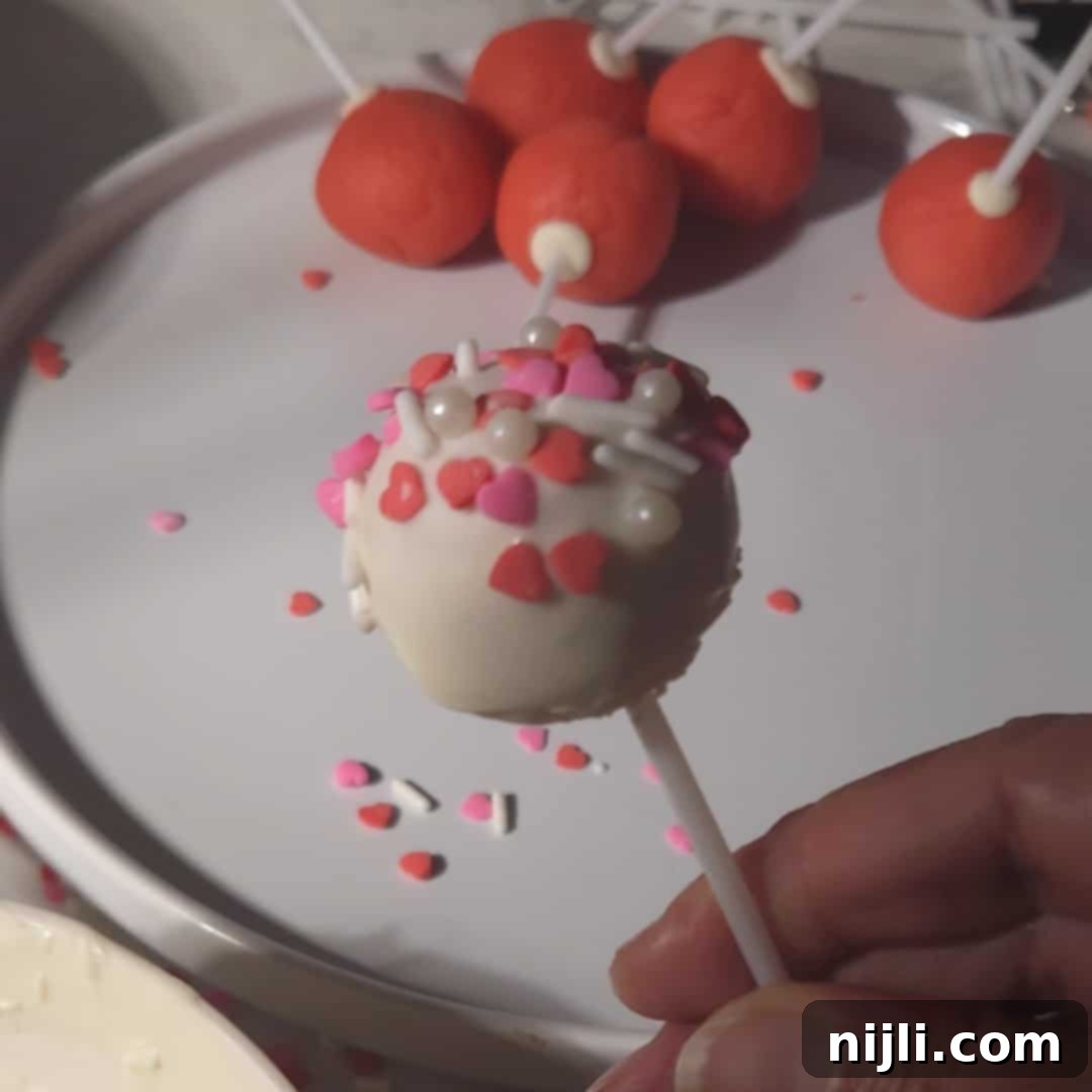 Sweetheart Cake Pops 11 A Valentine's day cake pop with sprinkles, ready to enjoy.