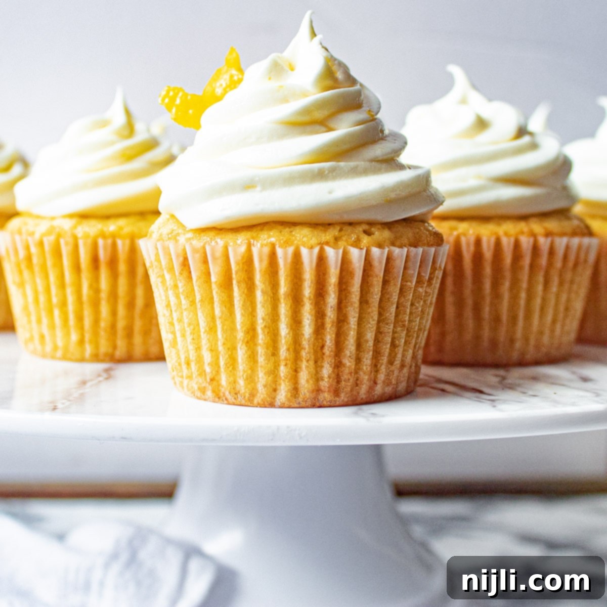 Aromatic Lavender Lemon Cupcakes 2 A tray filled with freshly baked lemon lavender cupcakes, beautifully frosted and ready to serve, highlighting their delicate purple hue and vibrant yellow lemon zest.