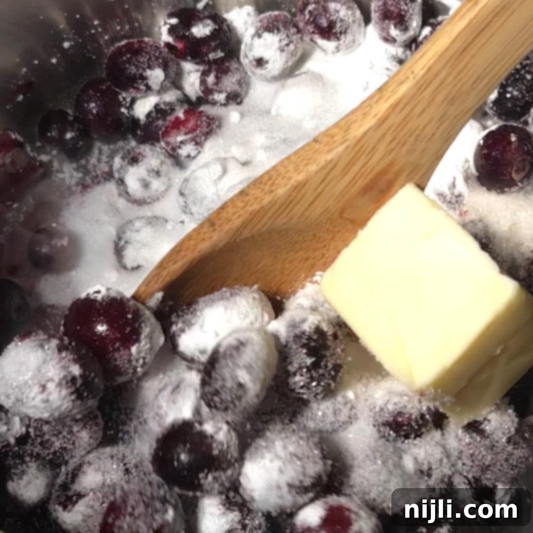 Heavenly Blueberry Cake Filling 6 Starting the blueberry cake filling with fresh blueberries, sugar, cornstarch, and butter in a saucepan, ready to be cooked down.