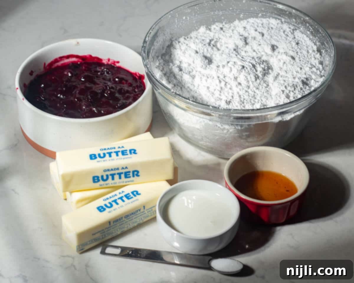 Chocolate Blueberry Delight 6 Ingredients for blueberry frosting displayed on a counter, including blueberry compote, powdered sugar, sticks of butter, cream, vanilla extract, and a pinch of salt.