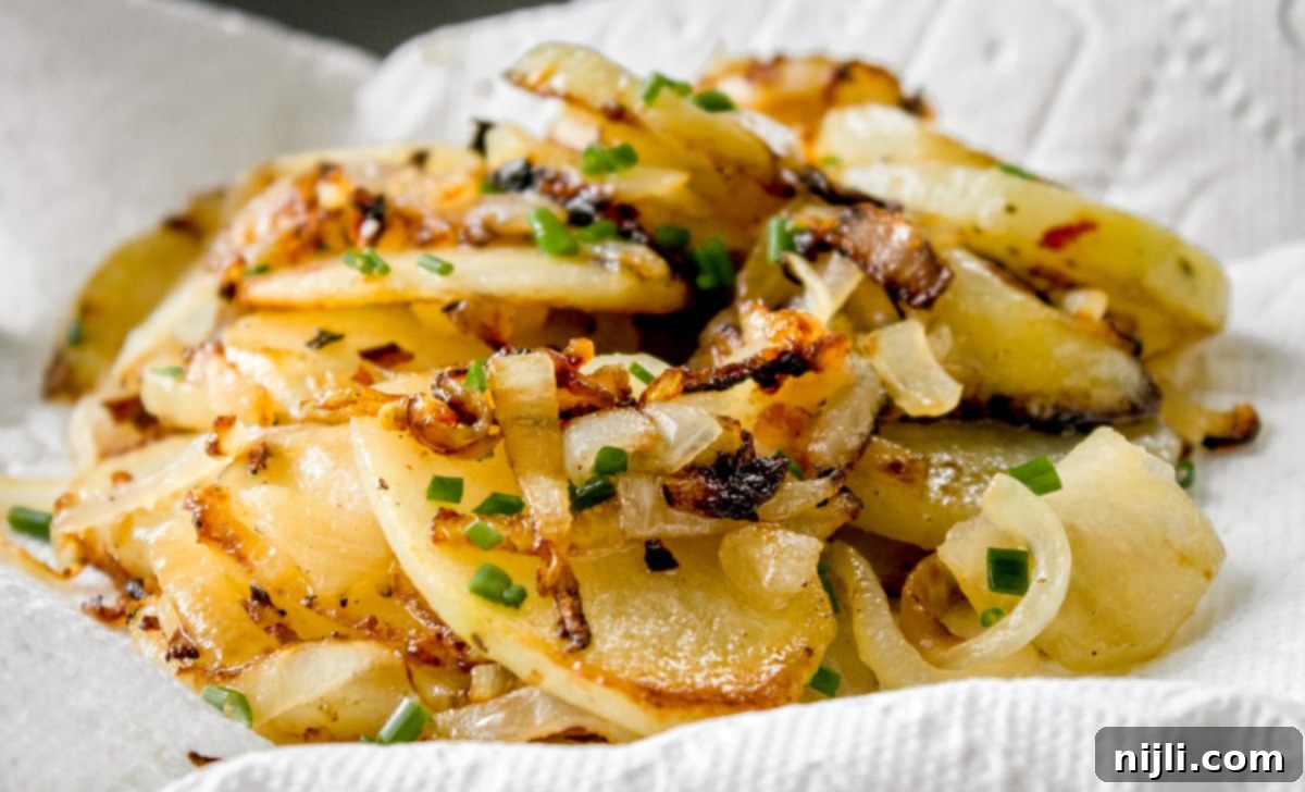 Skillet Potatoes and Onions 5 fried potatoes and onions on a paper towel
