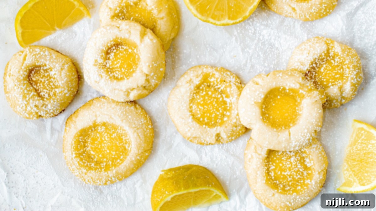 Lemon Curd's Sweetest Secrets 3 lemon curd cookies scattered on parchment paper
