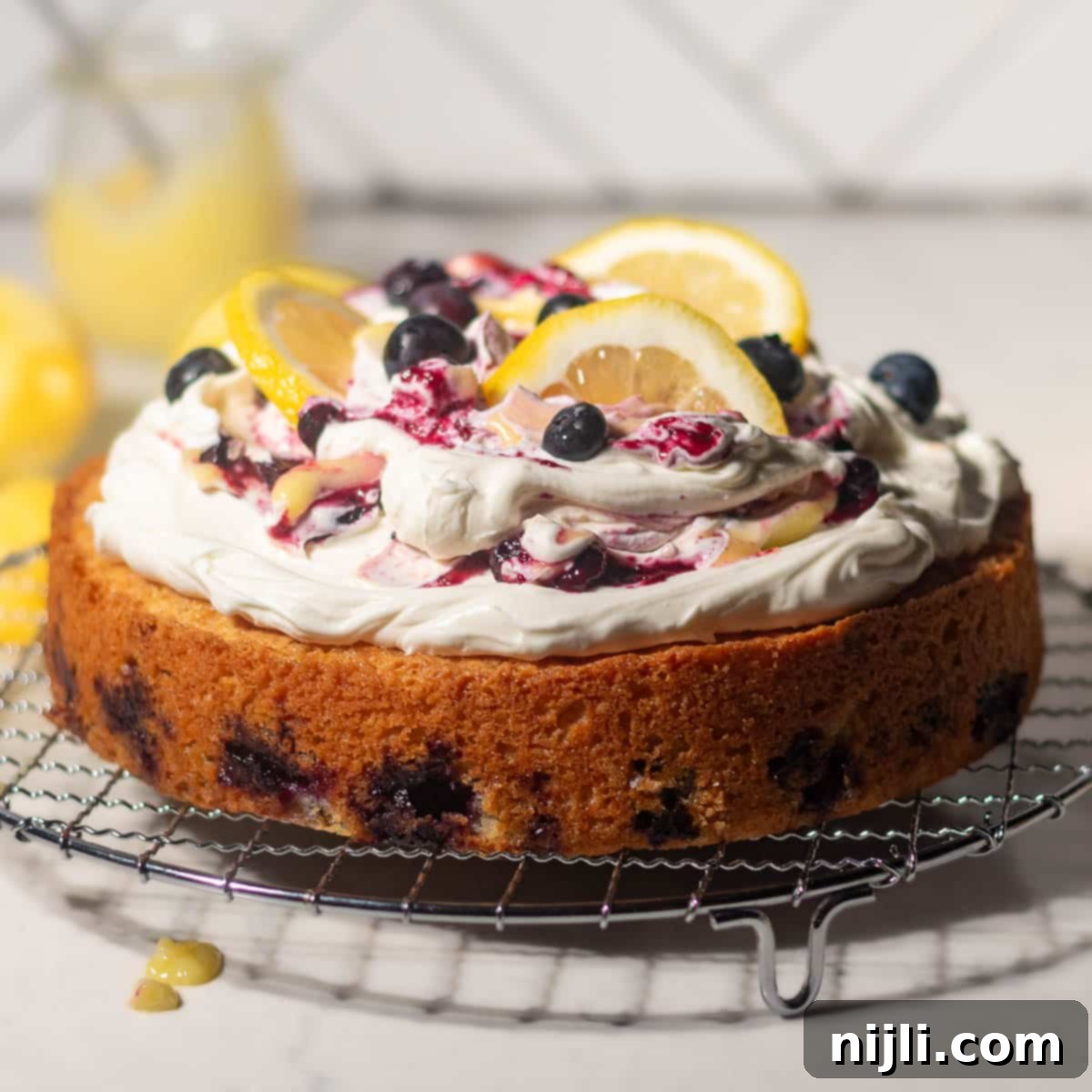 Sunny Lemon Blueberry Mascarpone Delight 2 The BEST Lemon Blueberry Mascarpone Cake with lemon curd and blueberry compote! That mascarpone frosting is to die for! You've got to try this easy lemon blueberry mascarpone cake from scratch!