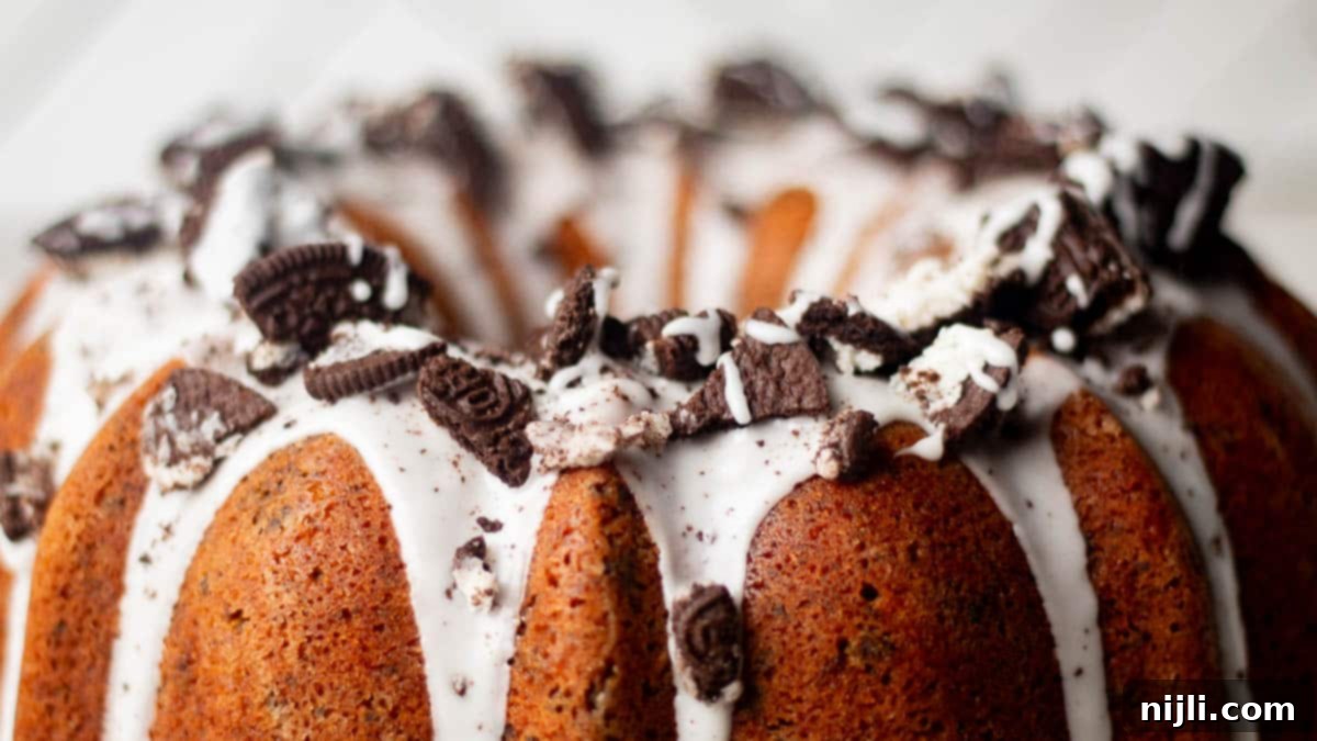Decadent Oreo Pound Cake 5 Overhead center-focused image of Oreo pound cake with crushed cookies and white glaze pooling between the cake’s ridges.