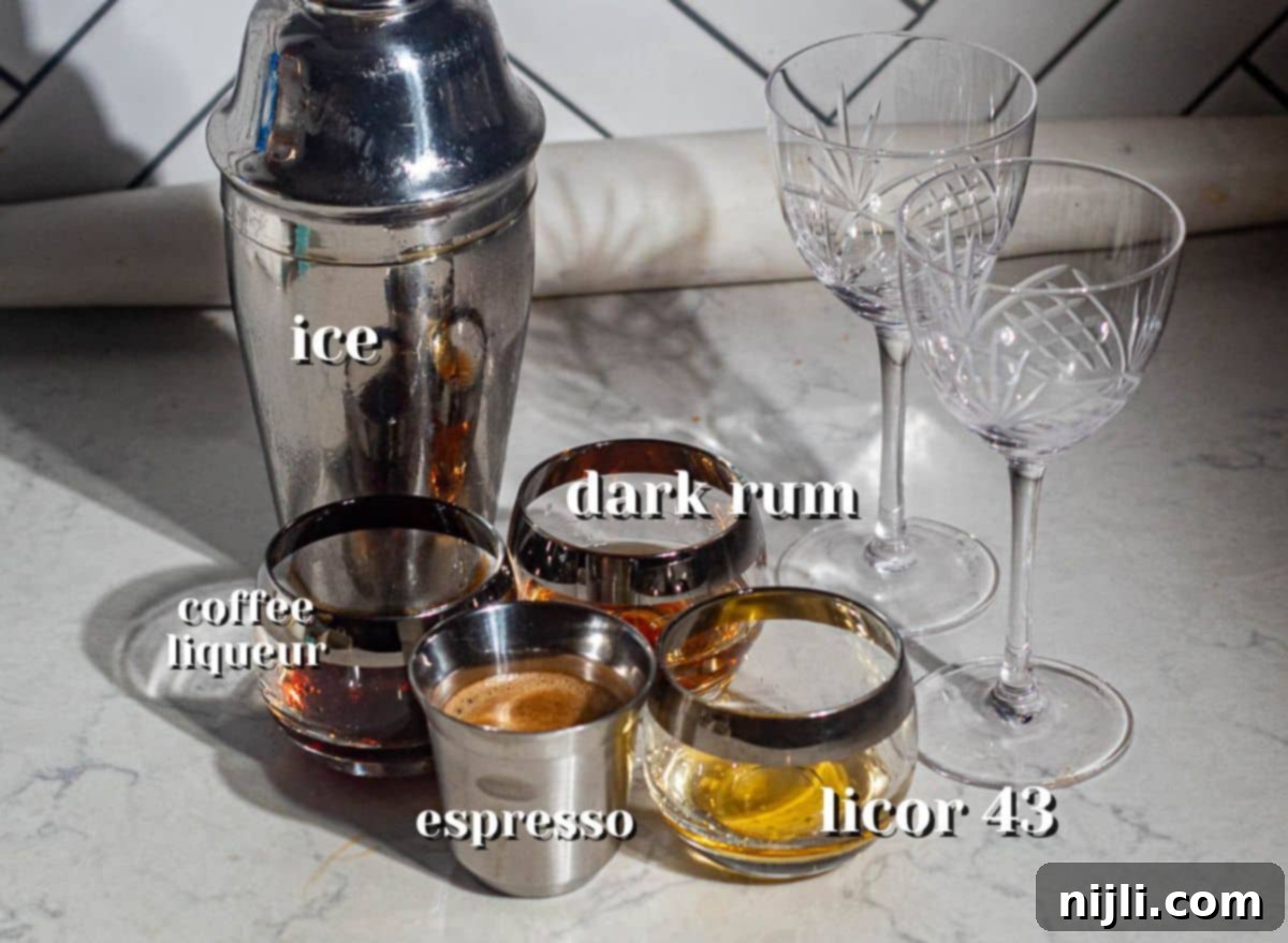 Ingredients for rum espresso martini including dark rum, espresso, coffee liqueur, Licor 43, and ice next to cocktail glasses.