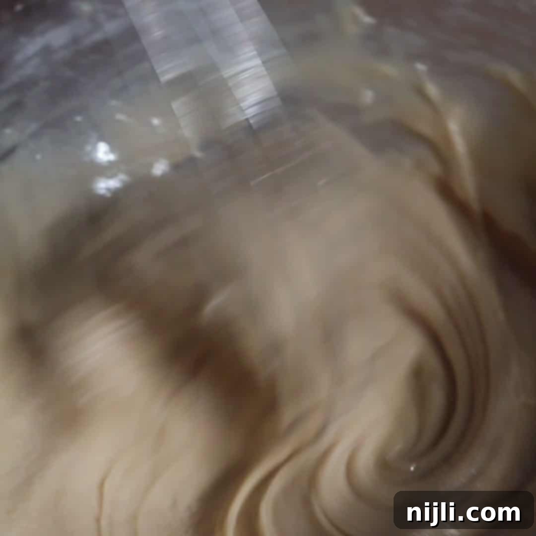 Brown Butter Bliss Cookies 12 Smooth brown sugar icing being whisked for brown butter sugar cookies.