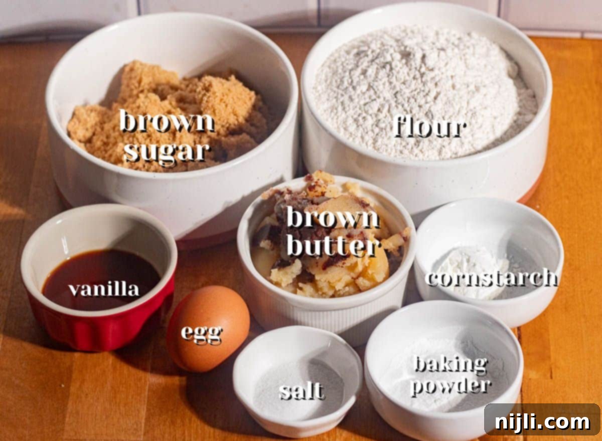 Brown Butter Bliss Cookies 4 Overhead of ingredients for brown butter sugar cookies, including brown sugar, flour, browned butter, egg, and vanilla.