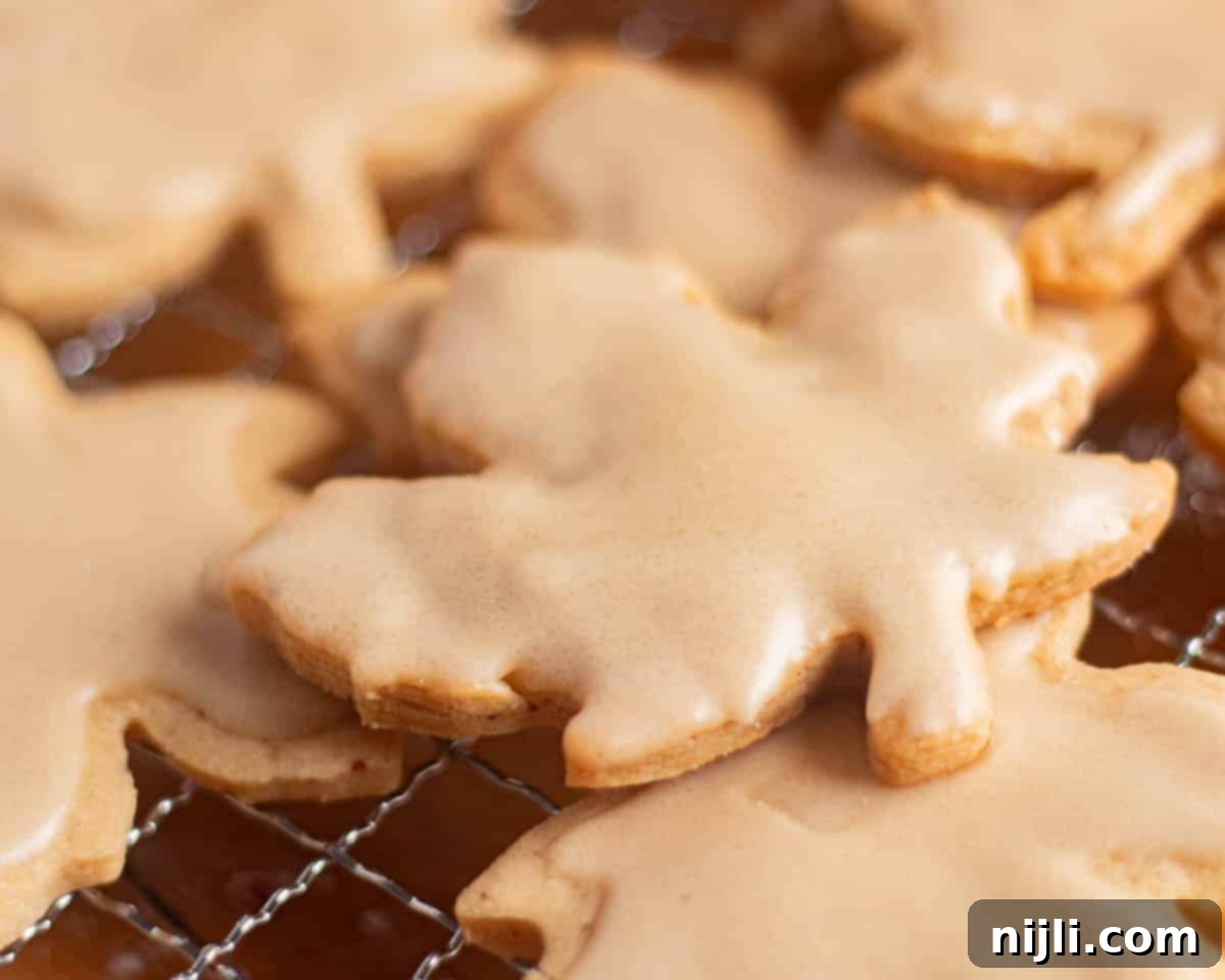 Brown Butter Bliss Cookies 5 Freshly baked brown butter sugar cookies decorated with glossy brown sugar icing on a cooling rack.