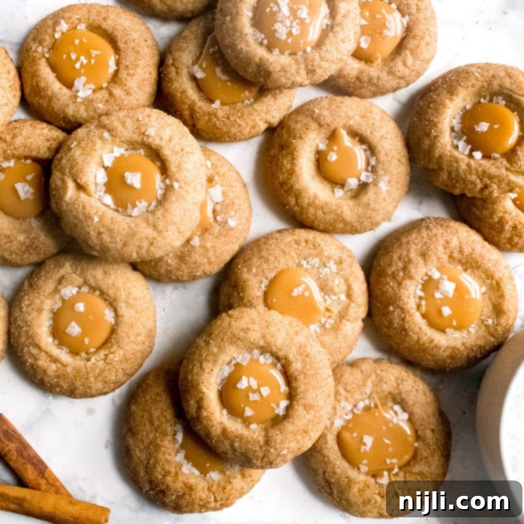 Sweet Salty Cinnamon Thumbprint Delights 2 Delicious salted caramel thumbprint cookies seen from above, garnished with flaky sea salt