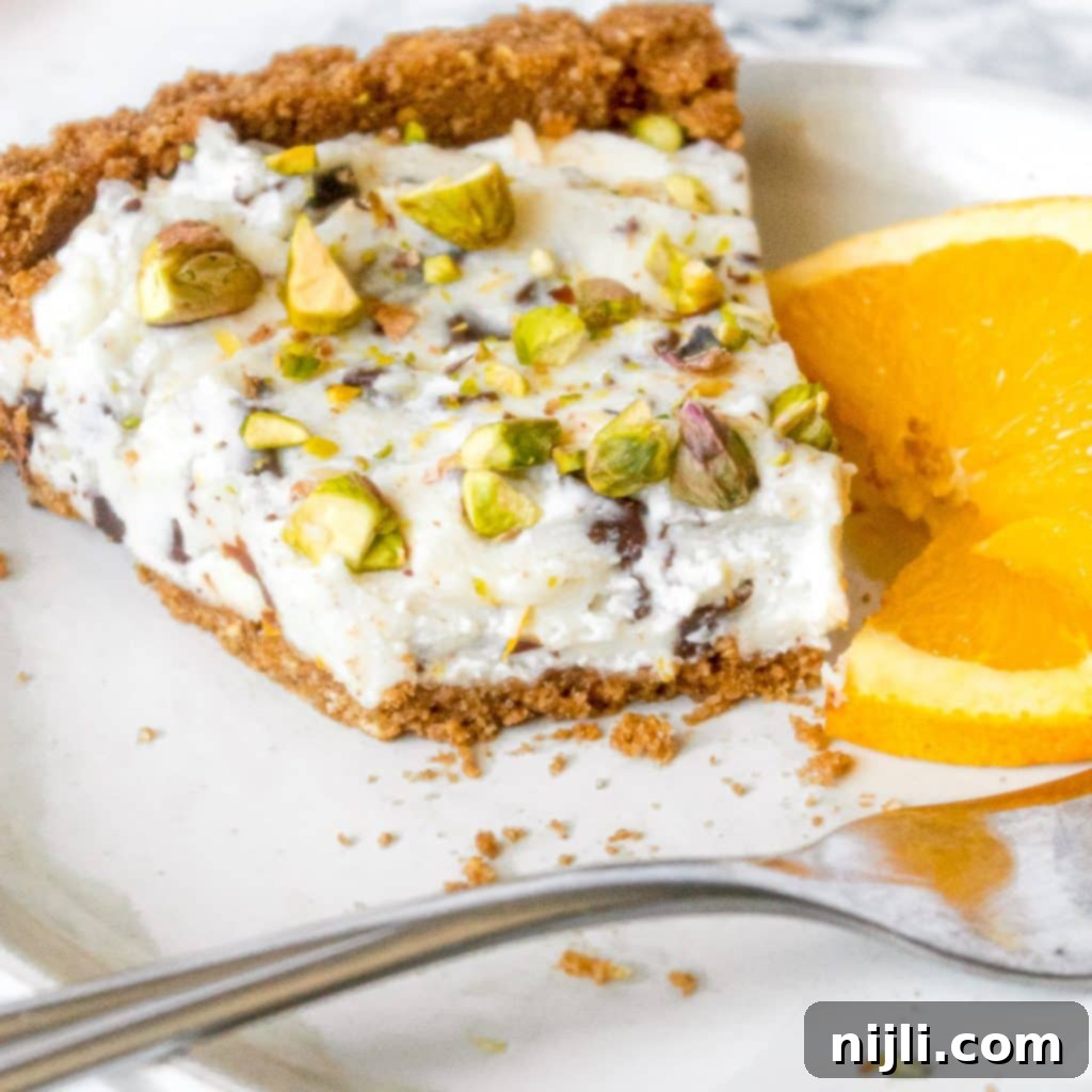 cannoli pie with a bite taken out, showing the creamy filling and crust