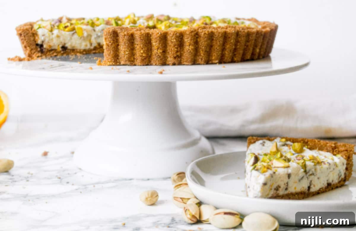 Cannoli Pie on a cake plate with a slice cut and more pie in background