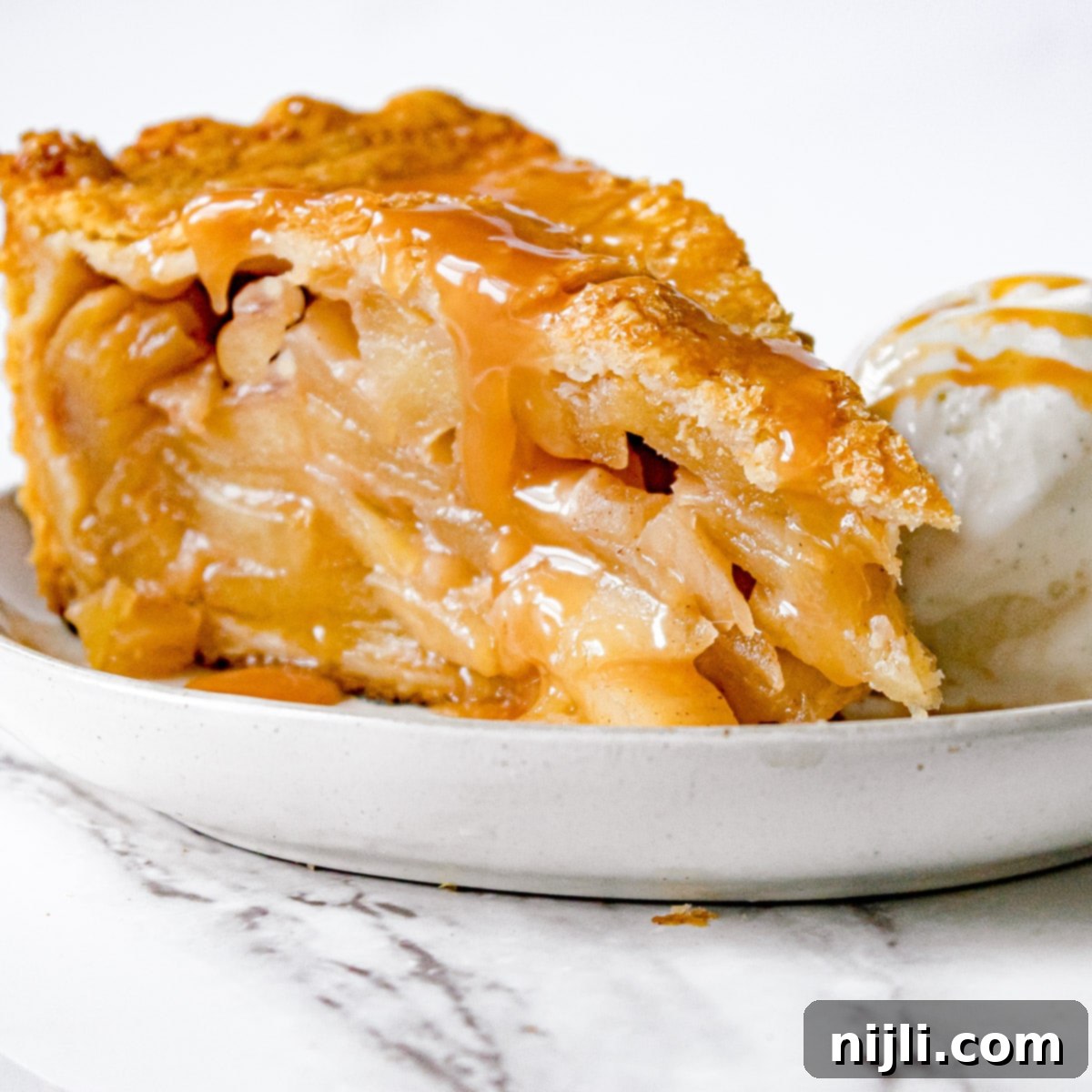 Decadent Deep Dish Caramel Apple Pie 2 slice of deep dish caramel apple pie with ice cream