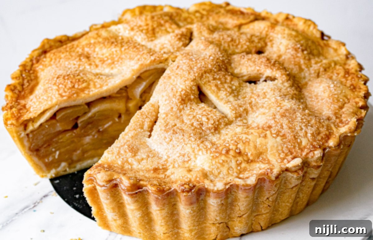 Decadent Deep Dish Caramel Apple Pie 3 whole deep dish caramel apple pie with a slice cut out