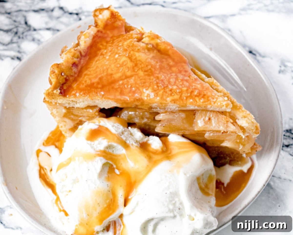 Decadent Deep Dish Caramel Apple Pie 7 slice of pie with caramel sauce and ice cream