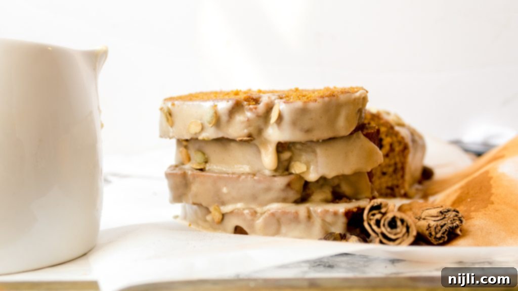 Harvest Gold Pumpkin Loaf, Maple Brown Butter Kissed 3 sliced pumpkin bread drizzled with glaze
