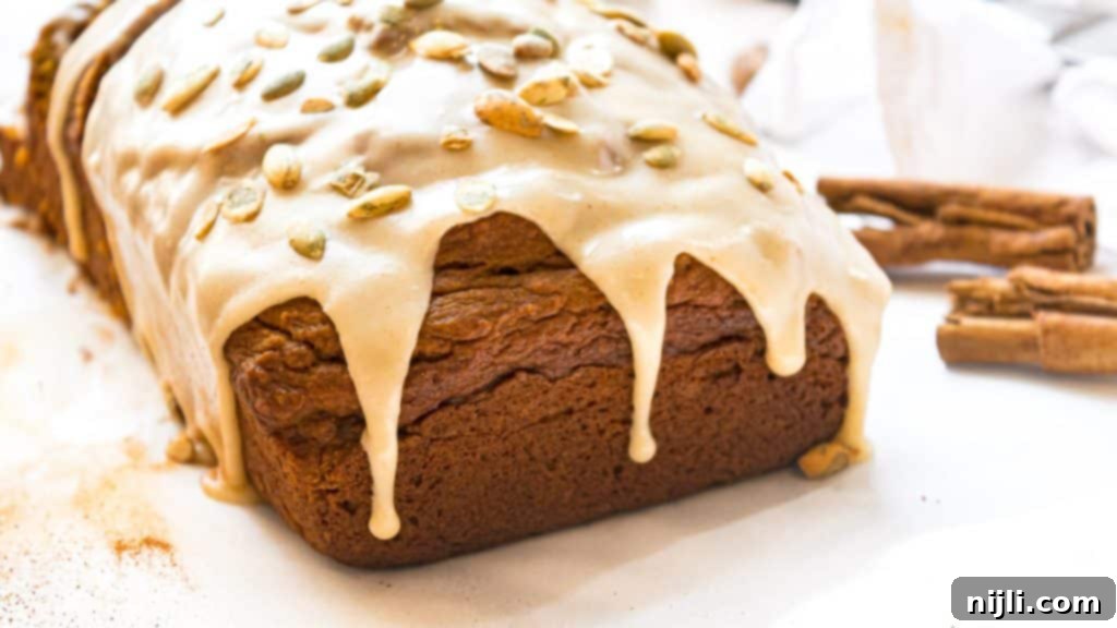 Harvest Gold Pumpkin Loaf, Maple Brown Butter Kissed 5 glaze dripping off of pumpkin bread loaf