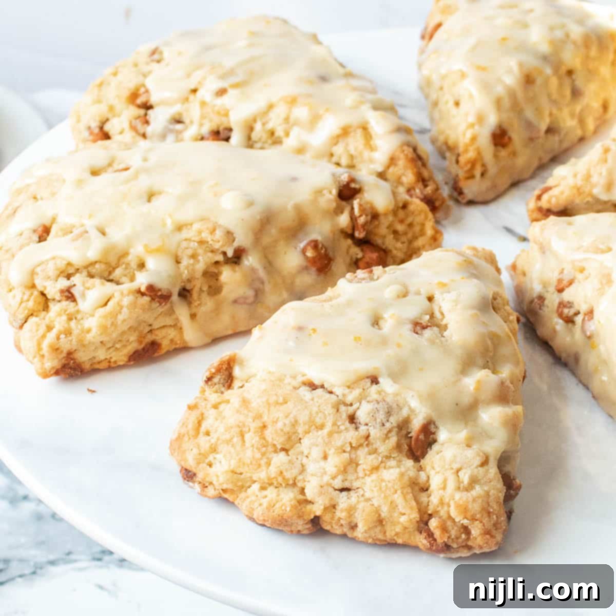 Spiced Orange Glazed Cinnamon Chip Scones 2 cinnamon chip scones (starbucks recipe) on a tray