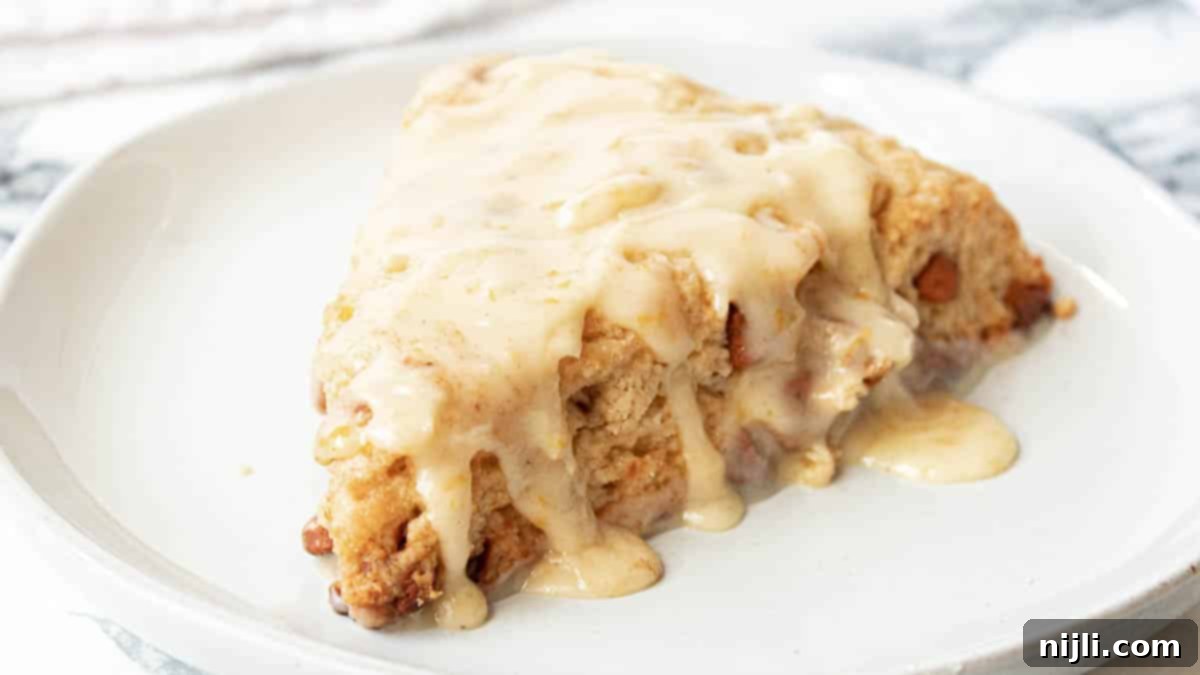 Spiced Orange Glazed Cinnamon Chip Scones 6 cinnamon chip scone on a plate with glaze