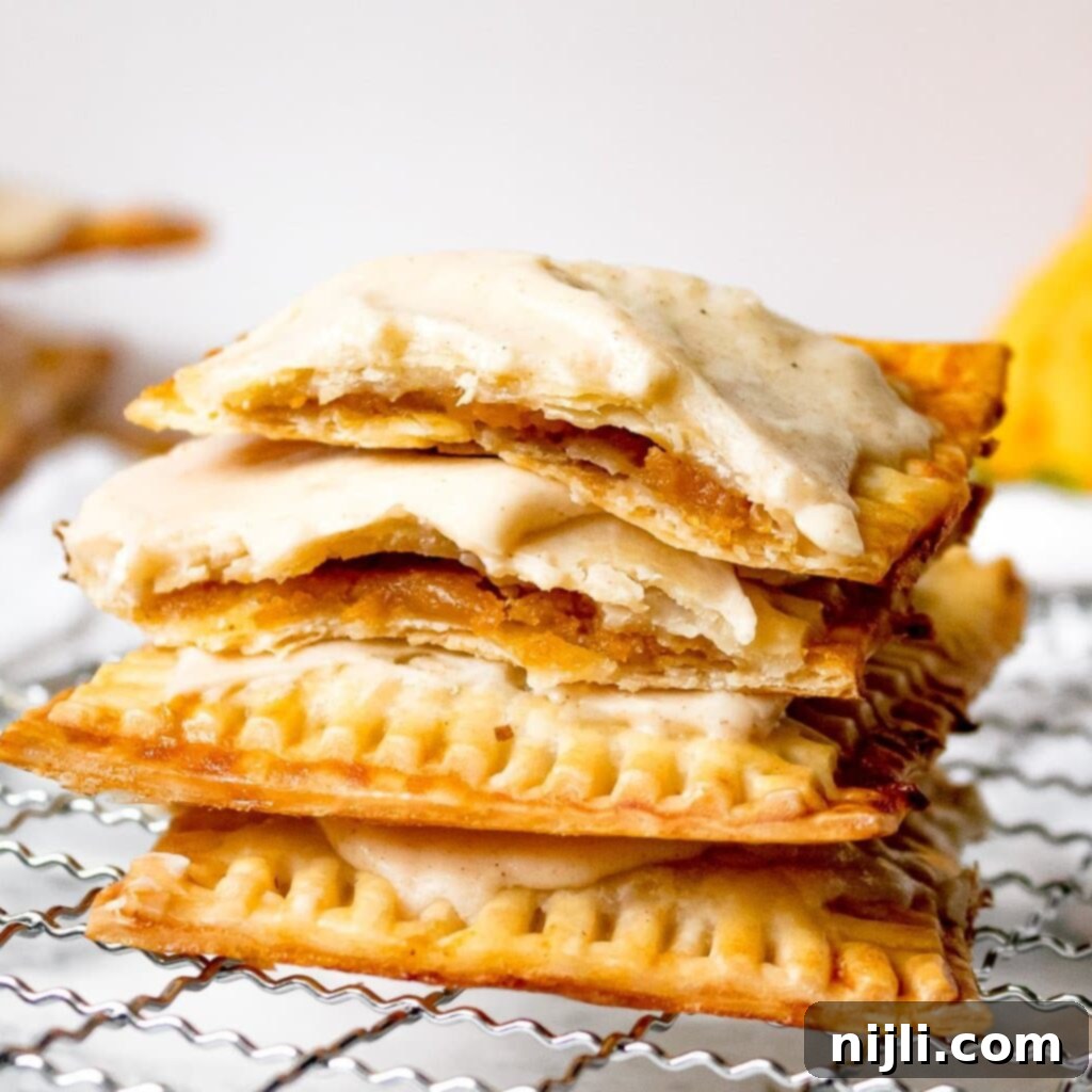 Spiced Sweet Potato Toaster Pastries 2 Easy Homemade Sweet Potato Pop Tarts with Brown Butter Icing on a white plate with a fork.