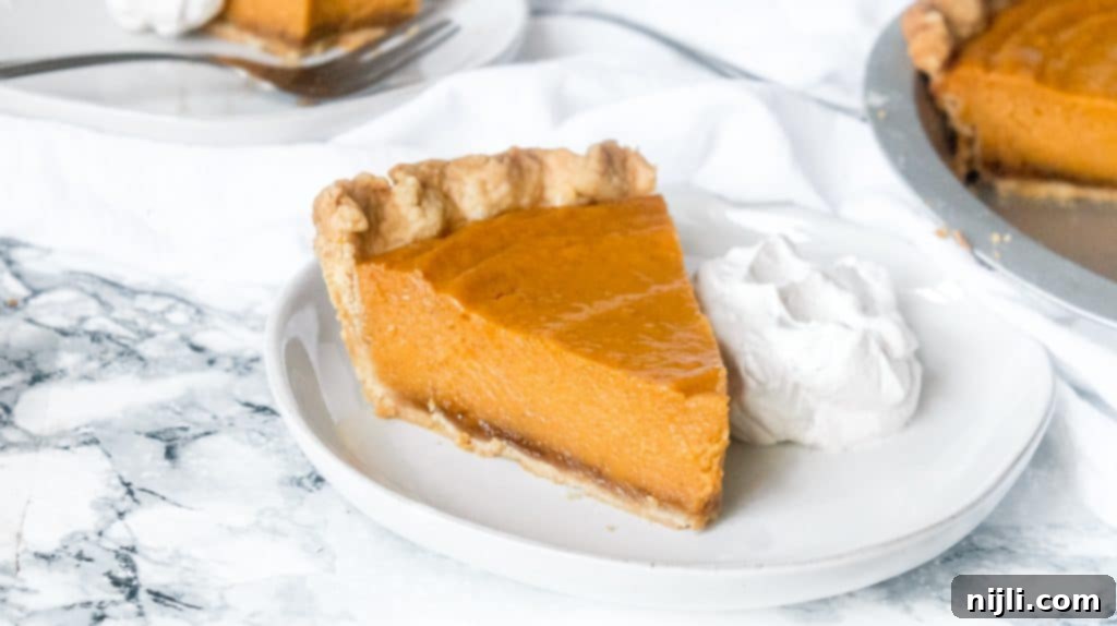 Spiced Sweet Potato Toaster Pastries 4 Slice of Brown Butter Black-Bottom Sweet Potato Pie on a plate with whipped cream.