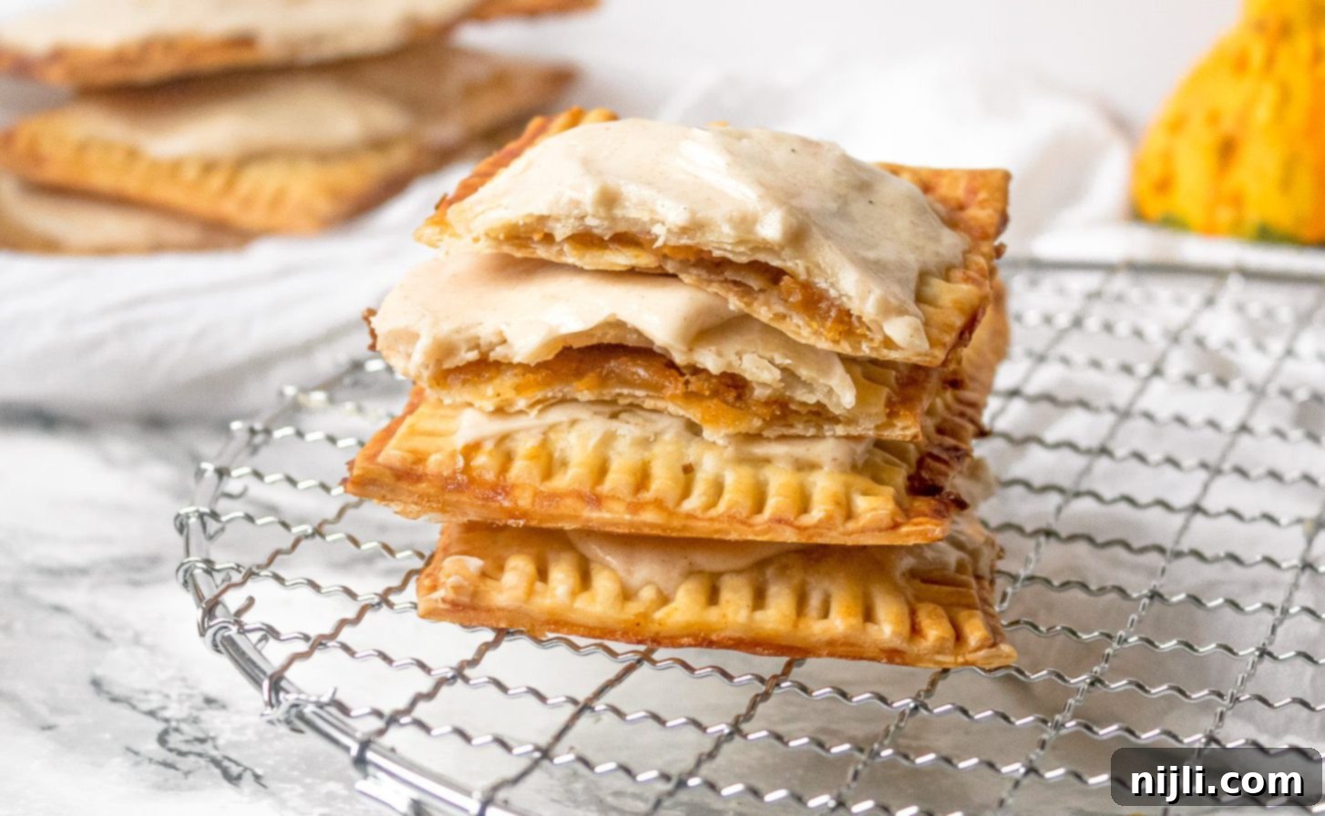 Spiced Sweet Potato Toaster Pastries 5 Easy Homemade Sweet Potato Pop Tarts with Brown Butter Icing on a white plate.
