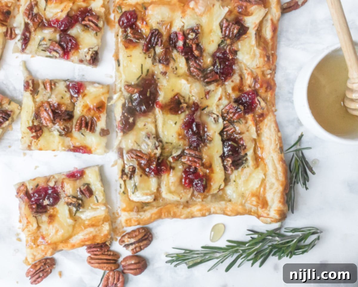 Vibrant Cranberry and Creamy Brie Tart 7 cut brie tart with honey