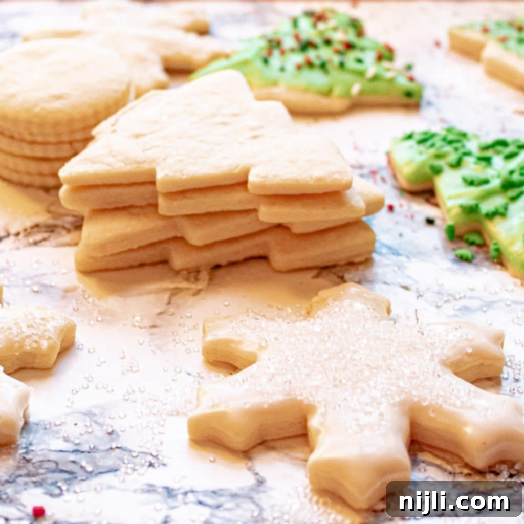 Perfectly Shaped Sugar Cookies 3 Stack of undecorated sugar cookies before decorating, dusted with powdered sugar