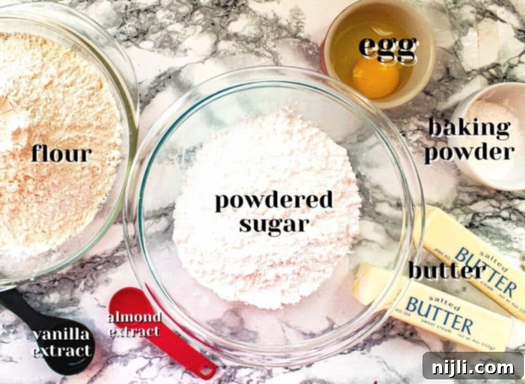 Perfectly Shaped Sugar Cookies 4 Ingredients for no spread sugar cookies laid out on a surface