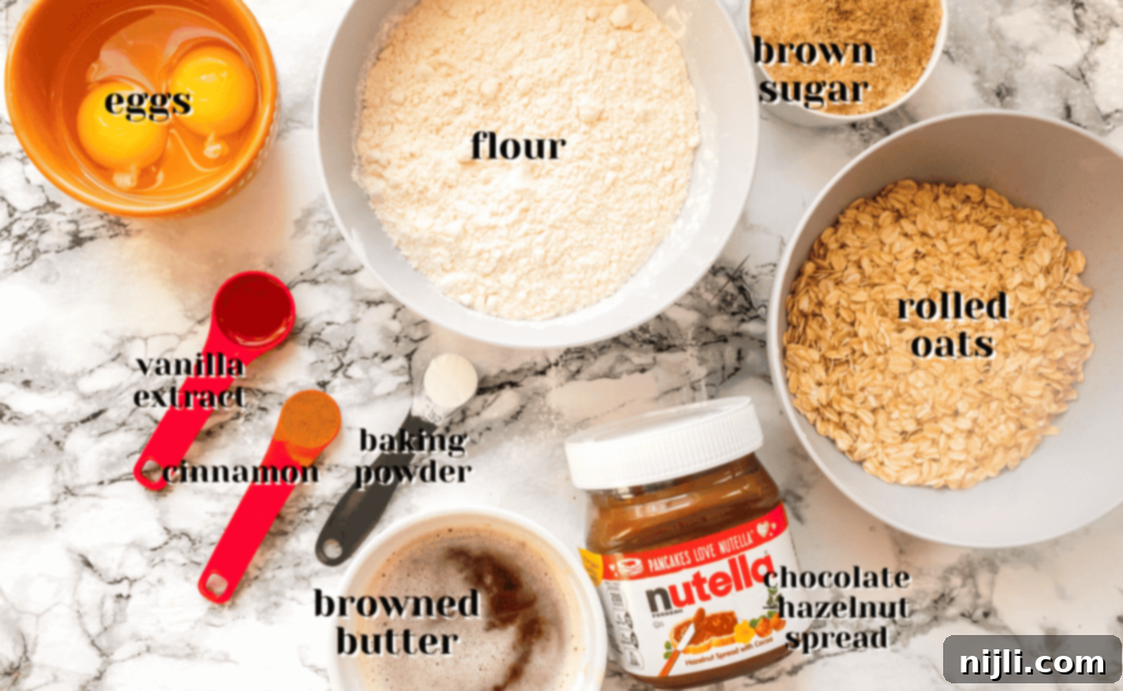 Salted Nutella Swirled Brown Butter Oatmeal Bars 3 A collection of ingredients laid out, including oats, flour, sugar, and baking essentials, ready for making delicious cookie bars.