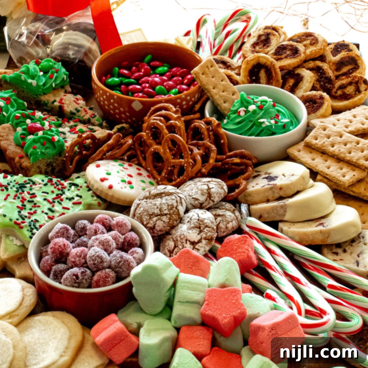 Holiday Grazing Board 3 Closeup of a festive dessert charcuterie board, showcasing an assortment of holiday sweets, cookies, and candy