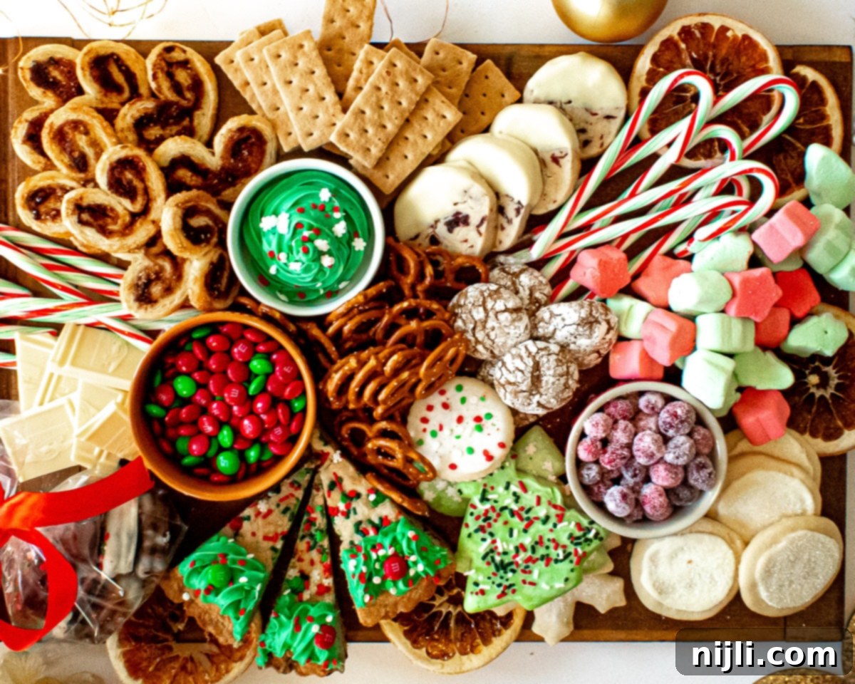Holiday Grazing Board 4 Overhead view of a lush Christmas dessert charcuterie board, showcasing a festive arrangement of sweets, fruits, and dips