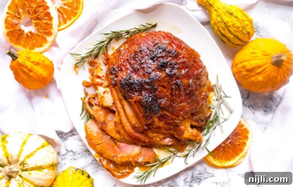 Overhead view of pressure cooker ham with gourds and dehydrated oranges