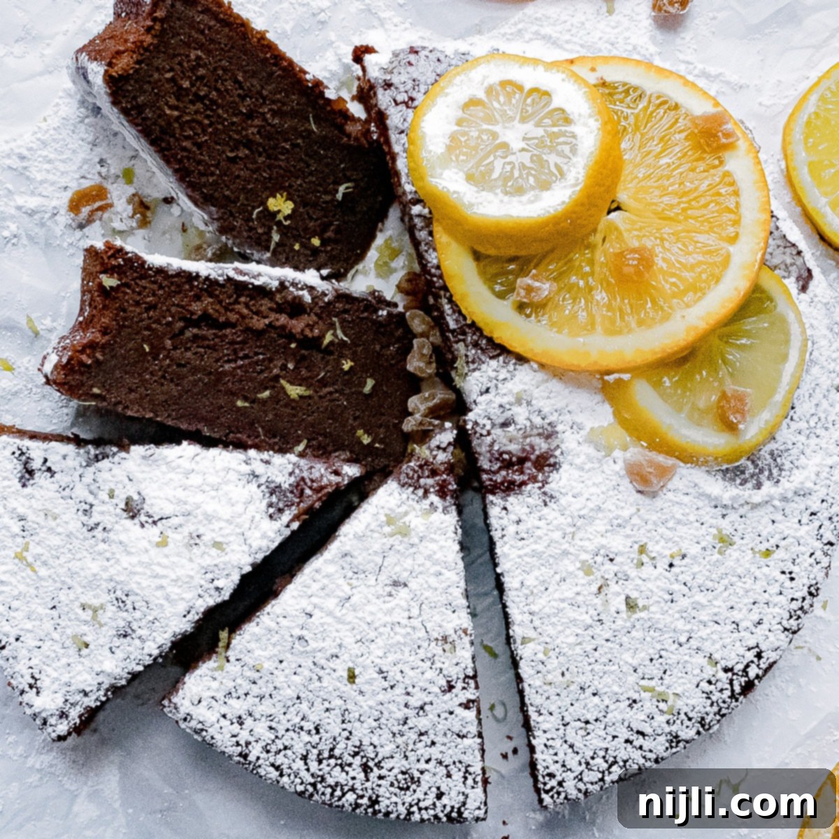 Decadent Chocolate Olive Oil Cake with Candied Ginger 2 A perfectly sliced chocolate olive oil cake on a serving tray, showcasing its moist texture and rich color.