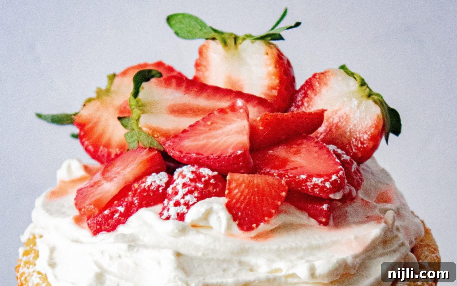 vanilla cake with strawberries on top