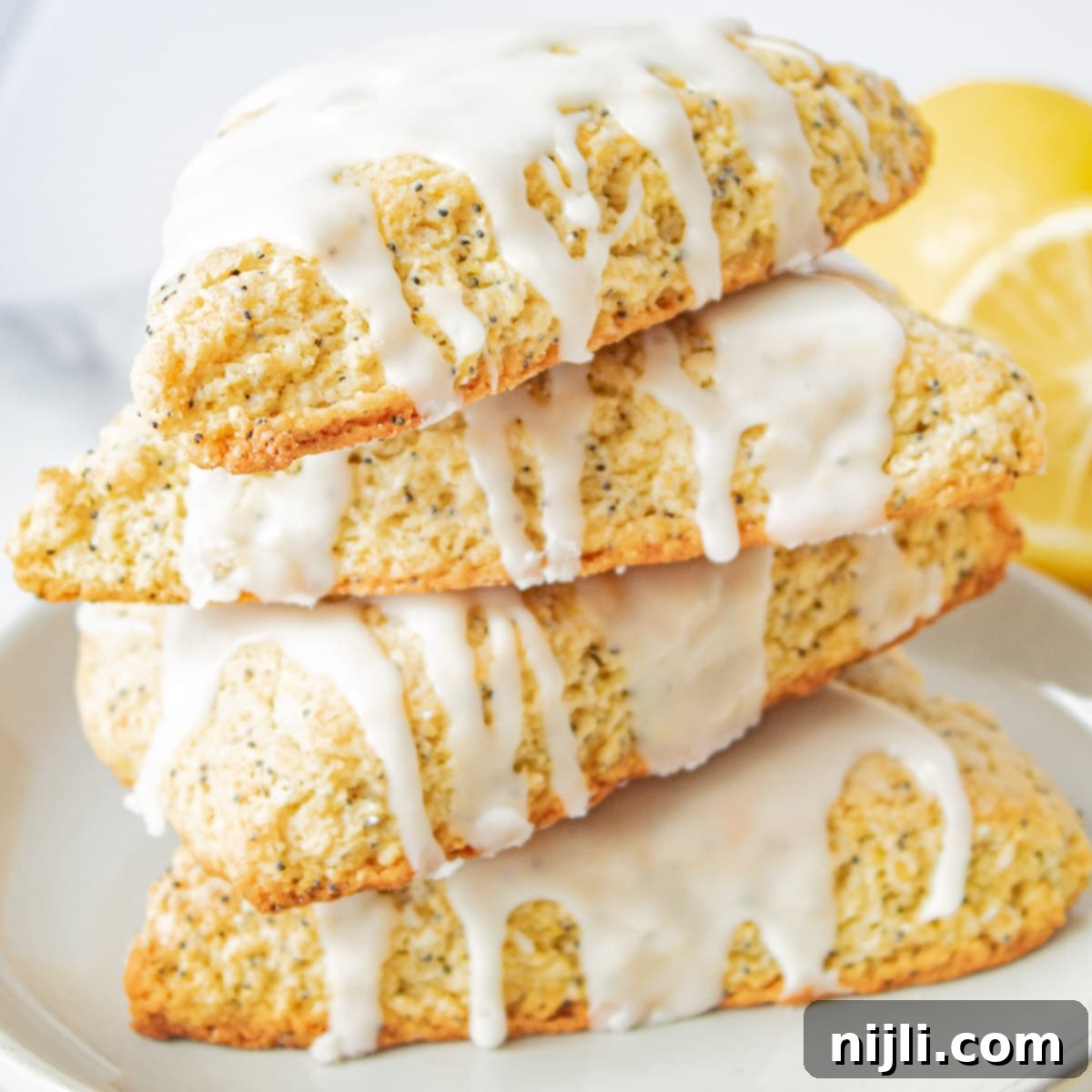 Zesty Lemon Poppyseed Scones 2 stacked lemon poppyseed scones